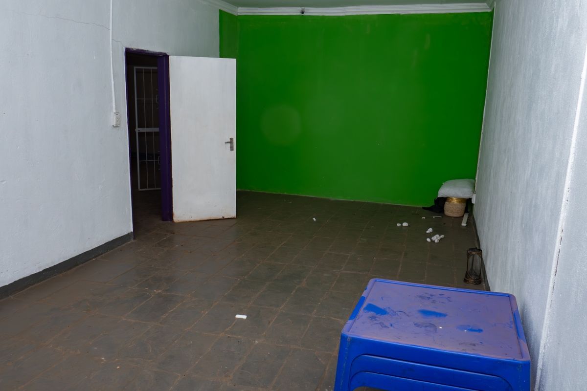 An empty bedroom featuring tiled flooring and painted walls, offering a blank canvas for renovation or interior design updates.
