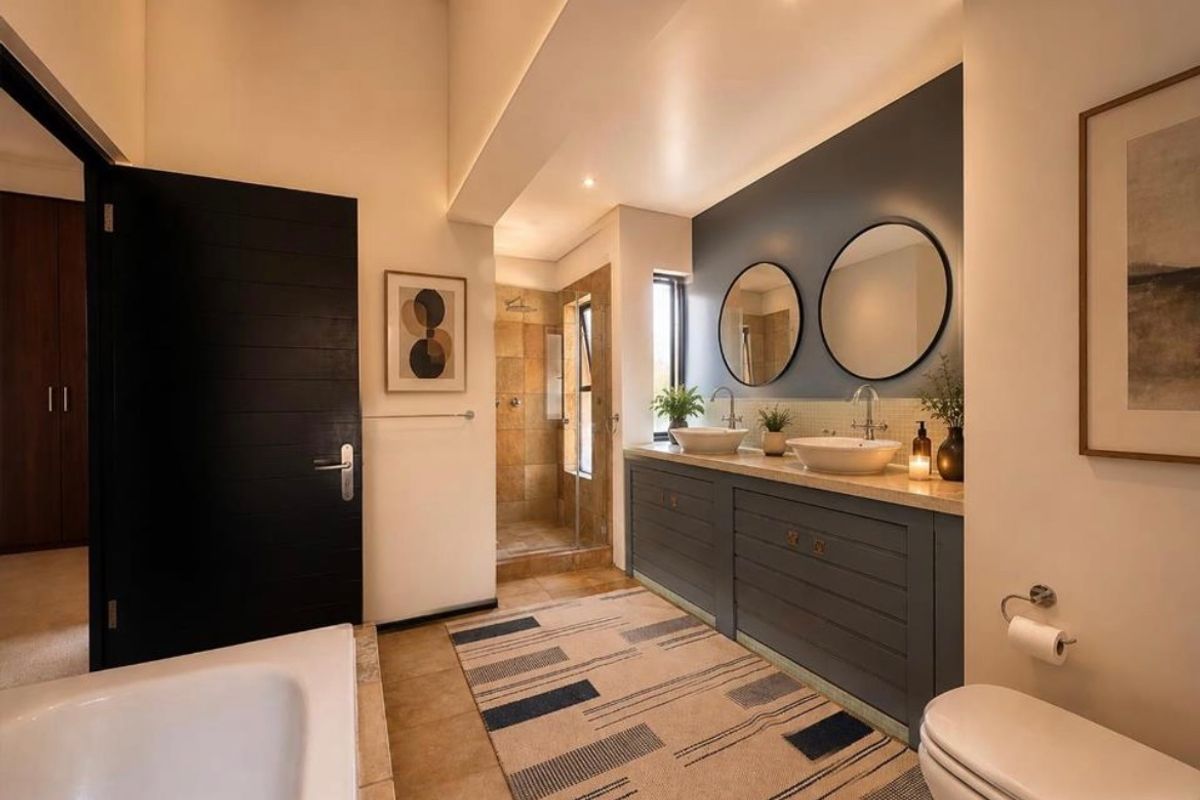 Modern bathroom featuring a double vanity with vessel sinks, a walk-in shower, and high-quality finishes throughout.