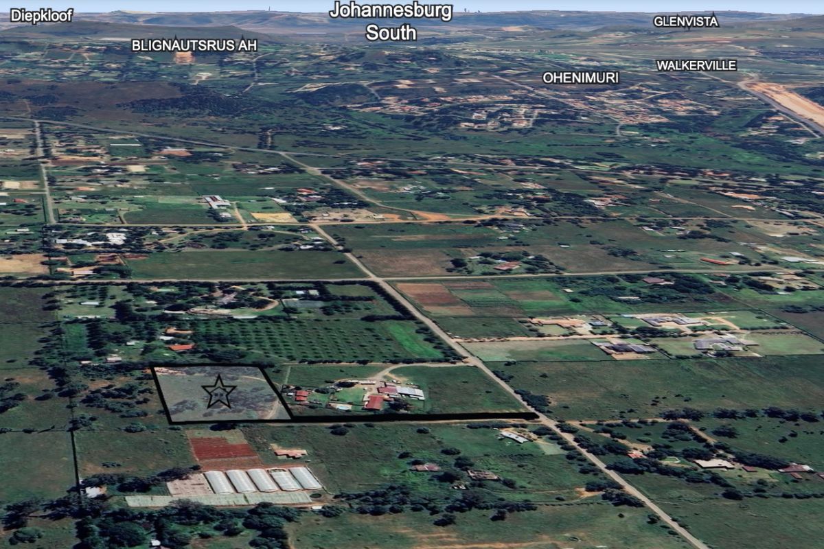 An aerial view of a residential vacant land plot in a rural setting, highlighting the location and surrounding landscape.