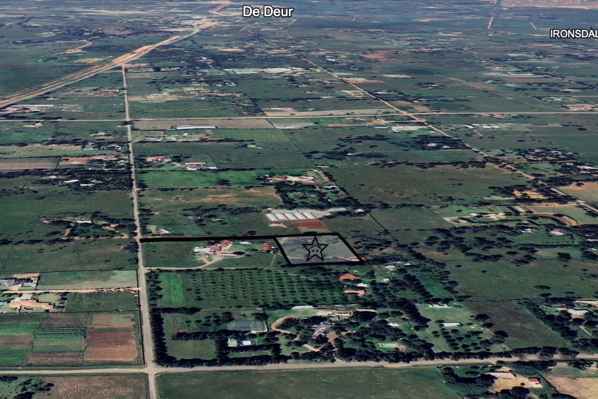 An aerial view of the residential vacant land plot located in the De Deur area, showing the surrounding landscape and property boundaries.