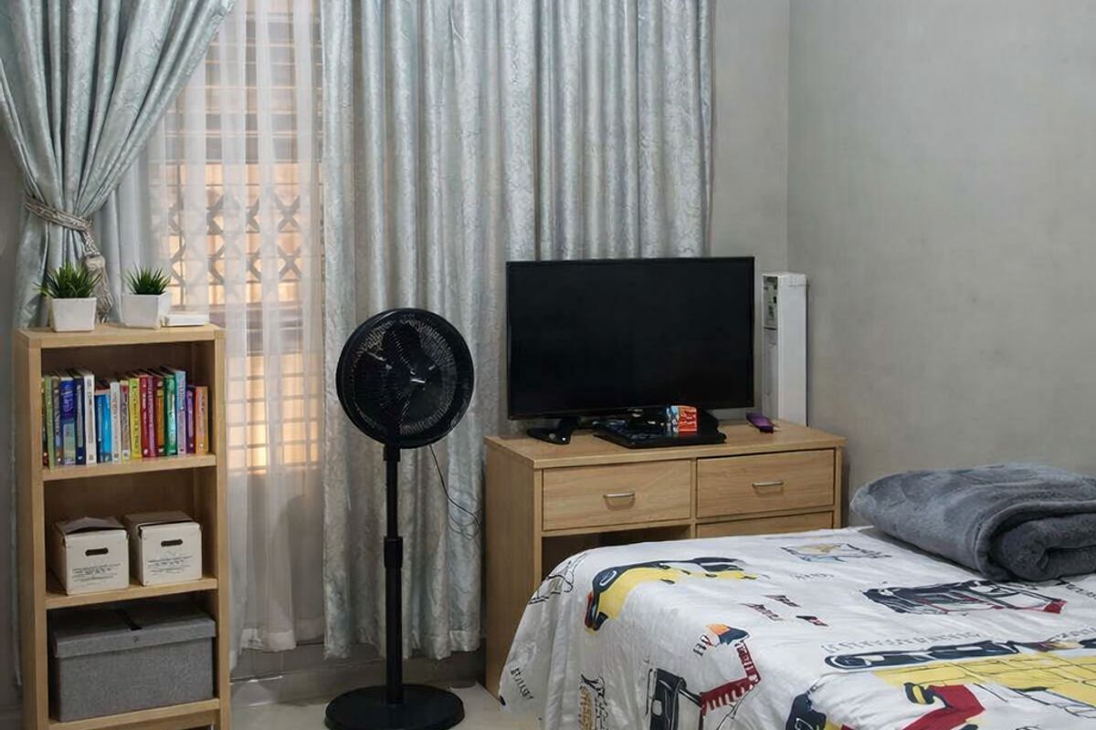 A well-maintained bedroom featuring neutral tiled flooring and decorative ceiling cornicing, providing a clean and functional living space.