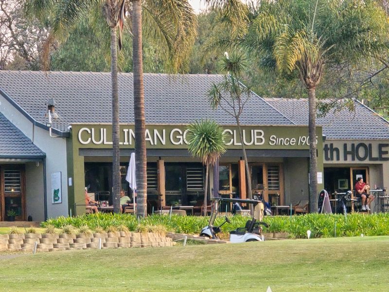 Exterior view of the Cullinan Golf Club clubhouse featuring a covered patio area and landscaped surroundings.