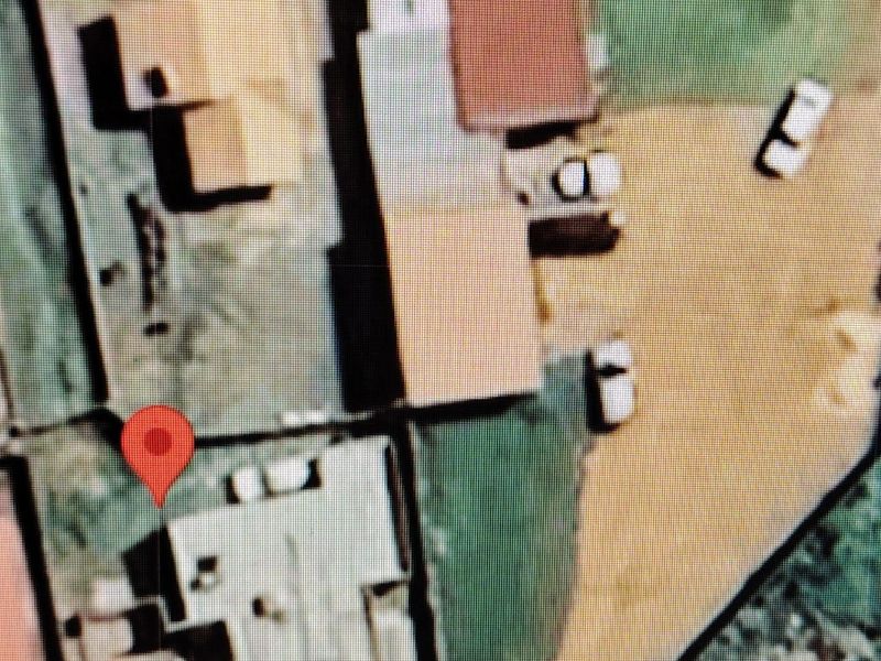 An aerial satellite view showing the property layout and surrounding site context.