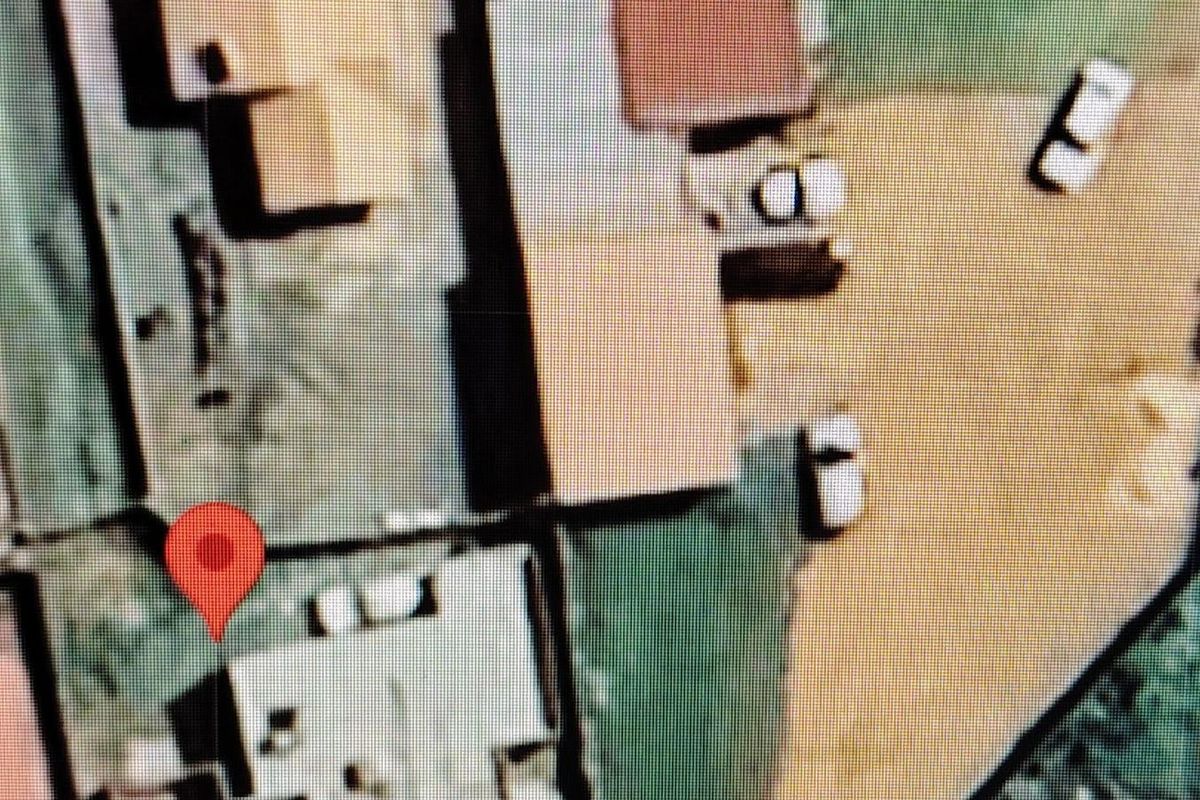 An aerial satellite view showing the property layout and surrounding site context.