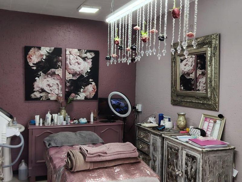 A treatment room featuring textured walls and integrated ceiling lighting, suitable for beauty or wellness services.