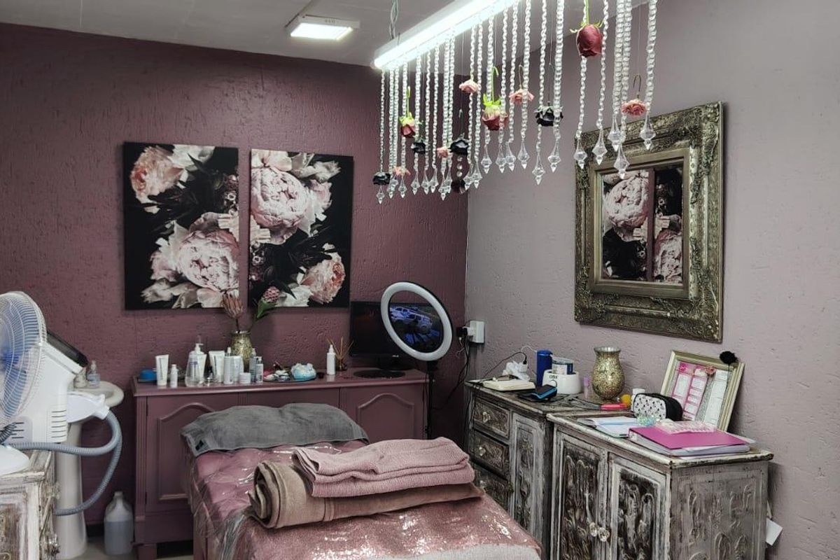 A treatment room featuring textured walls and integrated ceiling lighting, suitable for beauty or wellness services.