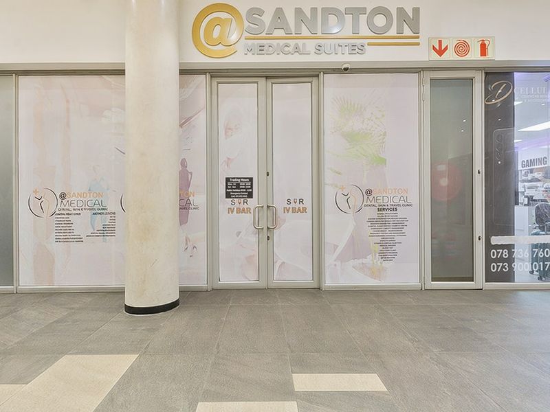 Commercial medical suite entrance featuring a glass storefront, aluminium door frames, and tiled flooring in a well-maintained professional building.