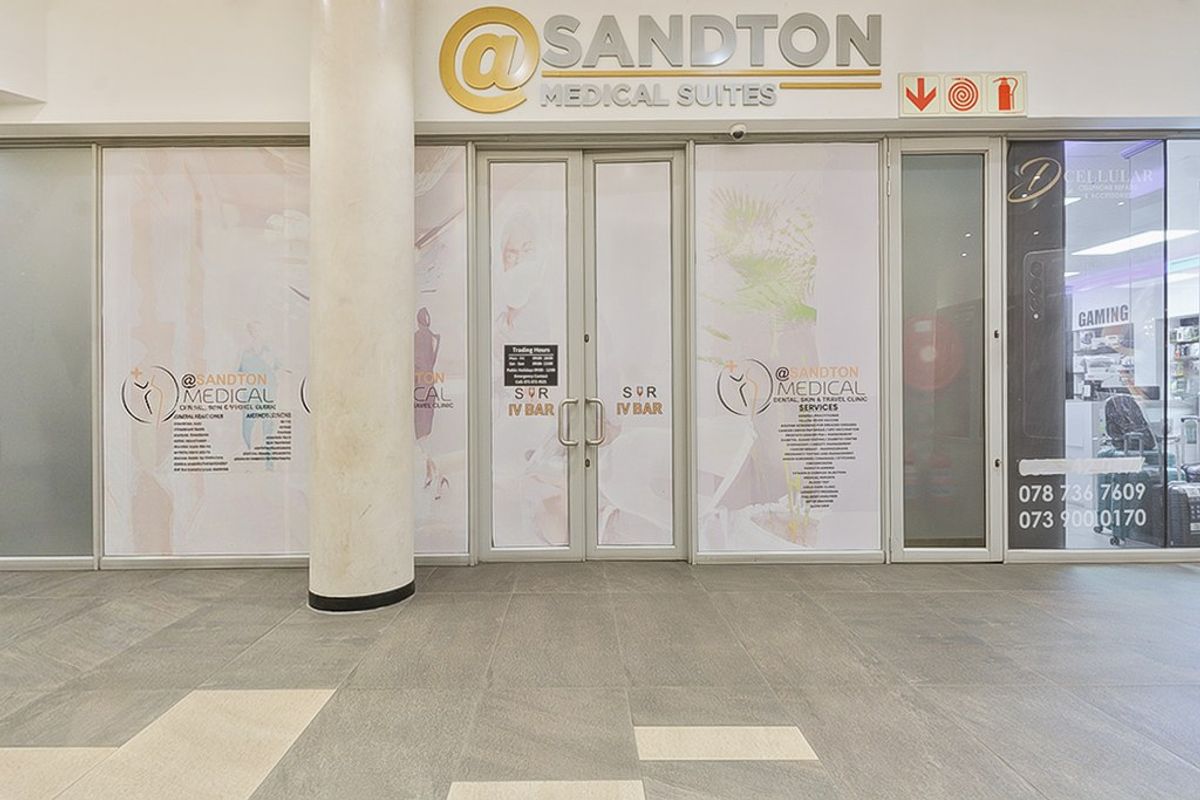Commercial medical suite entrance featuring a glass storefront, aluminium door frames, and tiled flooring in a well-maintained professional building.