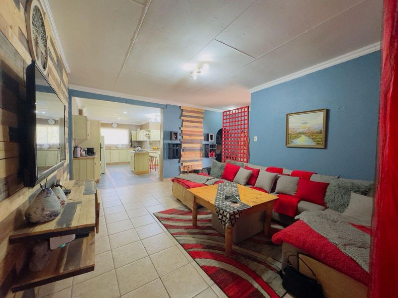 Open-plan living area featuring tiled flooring and a seamless transition into the adjacent kitchen space.