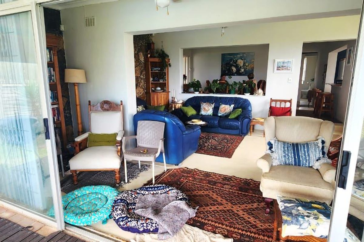 A spacious living area featuring large sliding glass doors that open to the outdoors and a convenient pass-through window connecting to adjacent rooms.