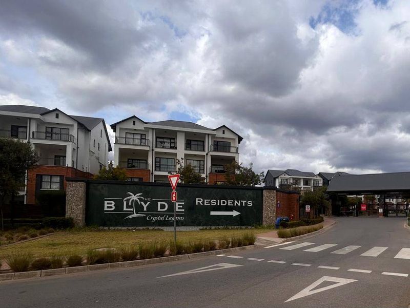 Street view of the entrance to The Blyde residential estate, featuring clear signage and well-maintained access roads.