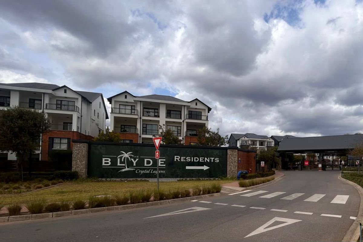Street view of the entrance to The Blyde residential estate, featuring clear signage and well-maintained access roads.