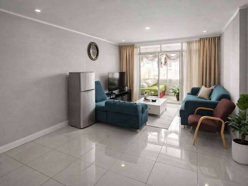 A bright living room featuring large format floor tiles, recessed lighting, and a sliding glass door providing access to an adjoining balcony.