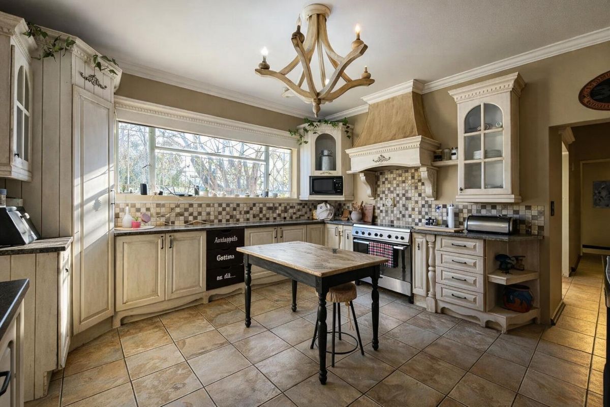 A rustic-style kitchen featuring custom cabinetry, a tiled backsplash, a built-in range with an extractor hood, and ceramic floor tiles.