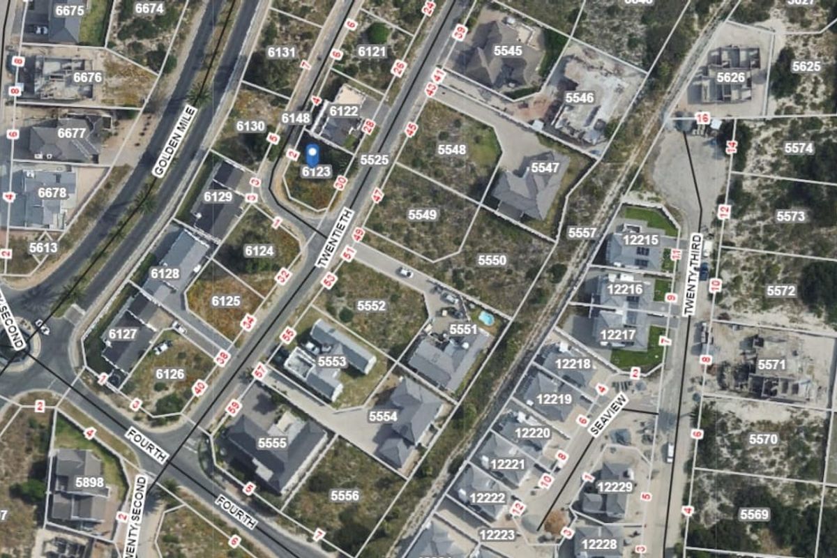 An aerial view of a residential neighborhood showing property boundaries, street layouts, and surrounding coastal landscape.