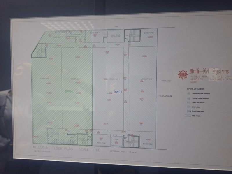 A detailed mezzanine floor plan for a commercial property, outlining various zones, meeting rooms, and fire safety systems.