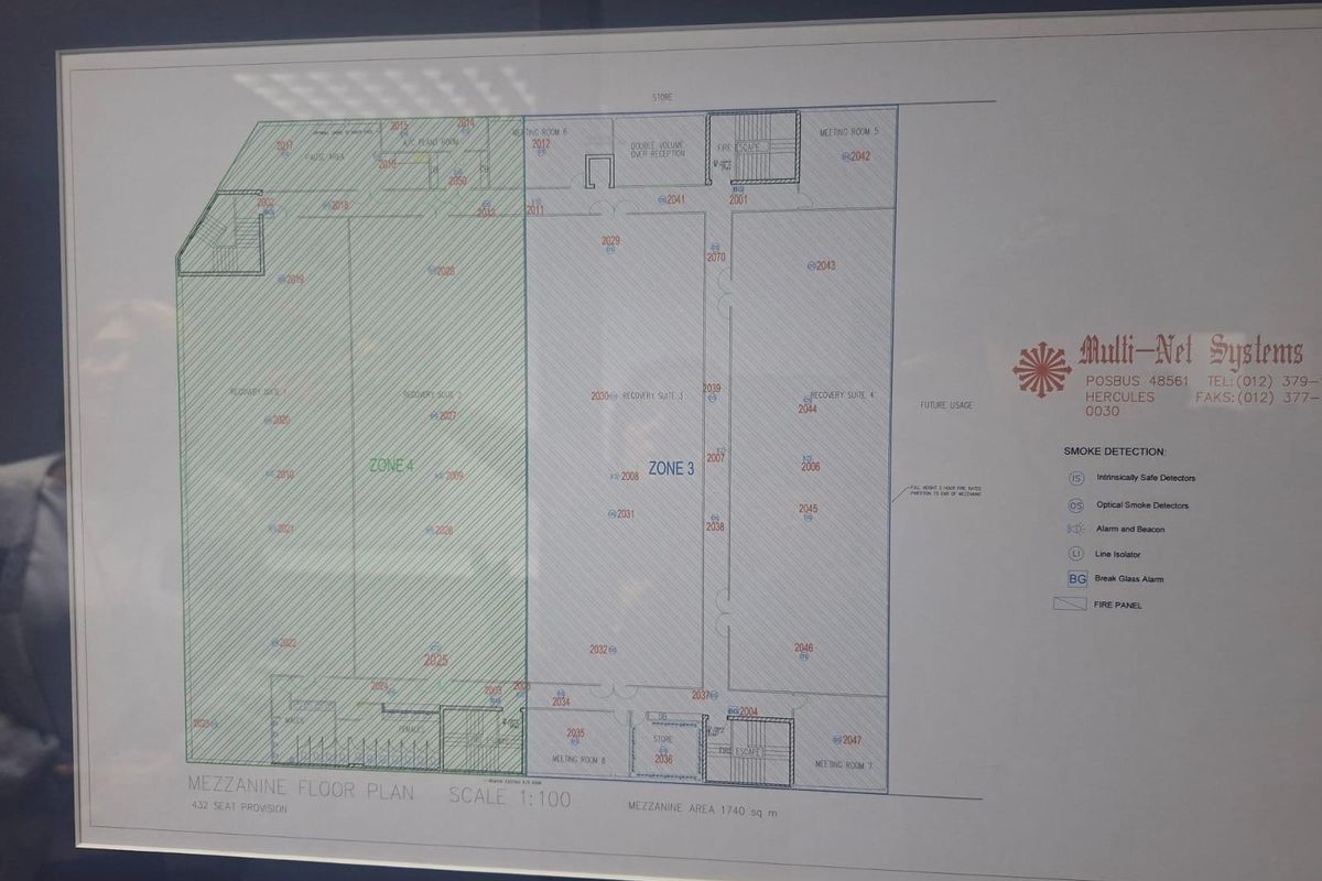 A detailed mezzanine floor plan for a commercial property, outlining various zones, meeting rooms, and fire safety systems.