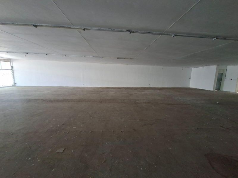 A large, vacant open-plan commercial space featuring raw concrete flooring and an exposed ceiling, suitable for various business fit-out configurations.