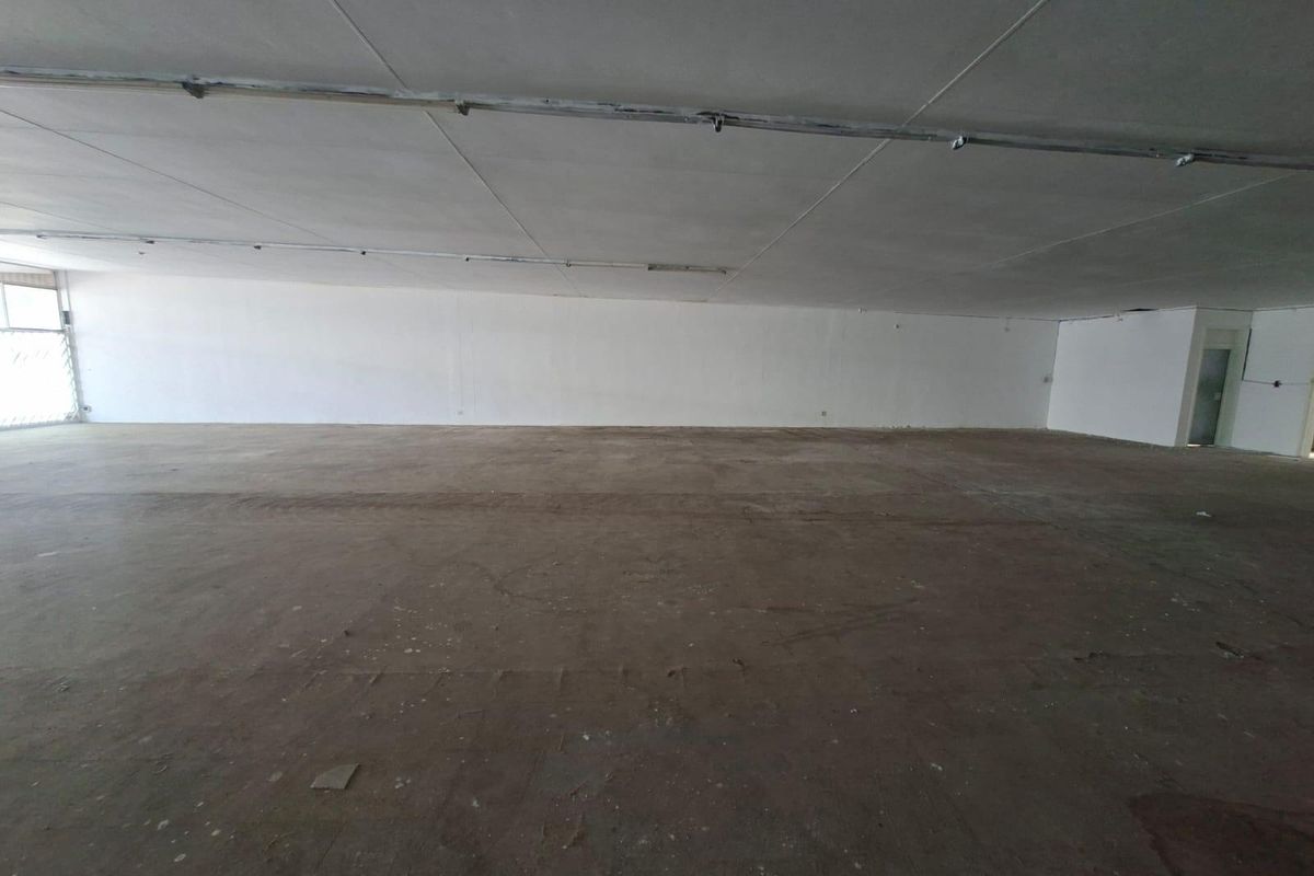 A large, vacant open-plan commercial space featuring raw concrete flooring and an exposed ceiling, suitable for various business fit-out configurations.