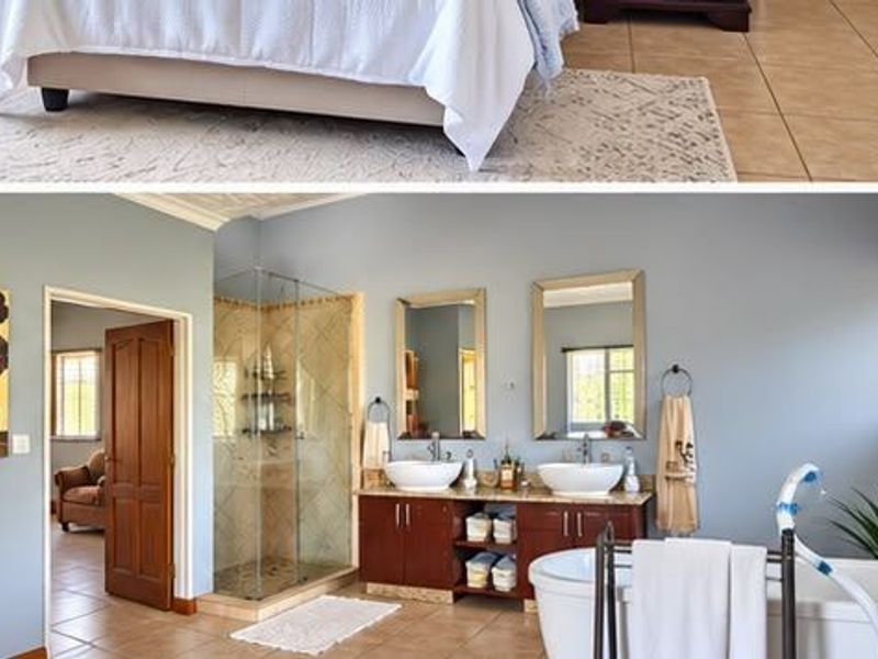 A spacious bathroom featuring a double vanity, glass-enclosed shower, and a freestanding bathtub with tiled flooring and neutral wall tones.