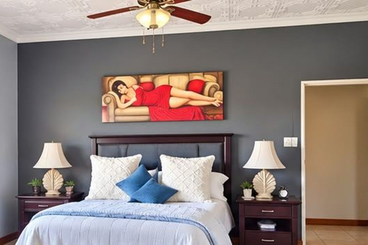 A well-maintained bedroom featuring decorative ceiling tiles, a ceiling fan, tiled flooring, and a solid timber door.