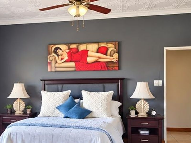 A well-maintained bedroom featuring decorative ceiling tiles, a ceiling fan, tiled flooring, and a solid timber door.