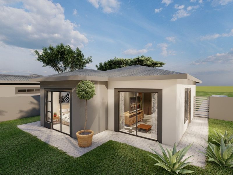 A modern rear exterior view of a house featuring sliding glass doors, a paved walkway, and a well-maintained garden area.