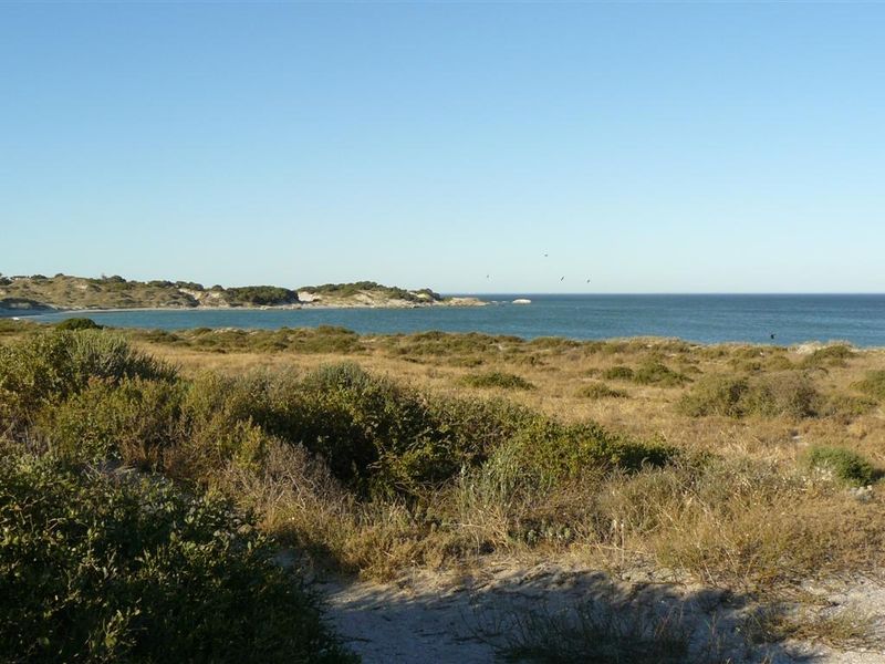 A scenic view of the coastal landscape and ocean, showcasing the natural beauty of the vacant residential land.