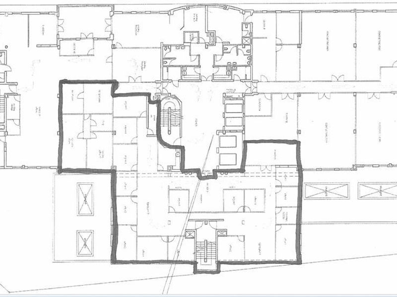 A detailed architectural floor plan illustrating the layout of the first floor, including various rooms, corridors, and stairwell access points.
