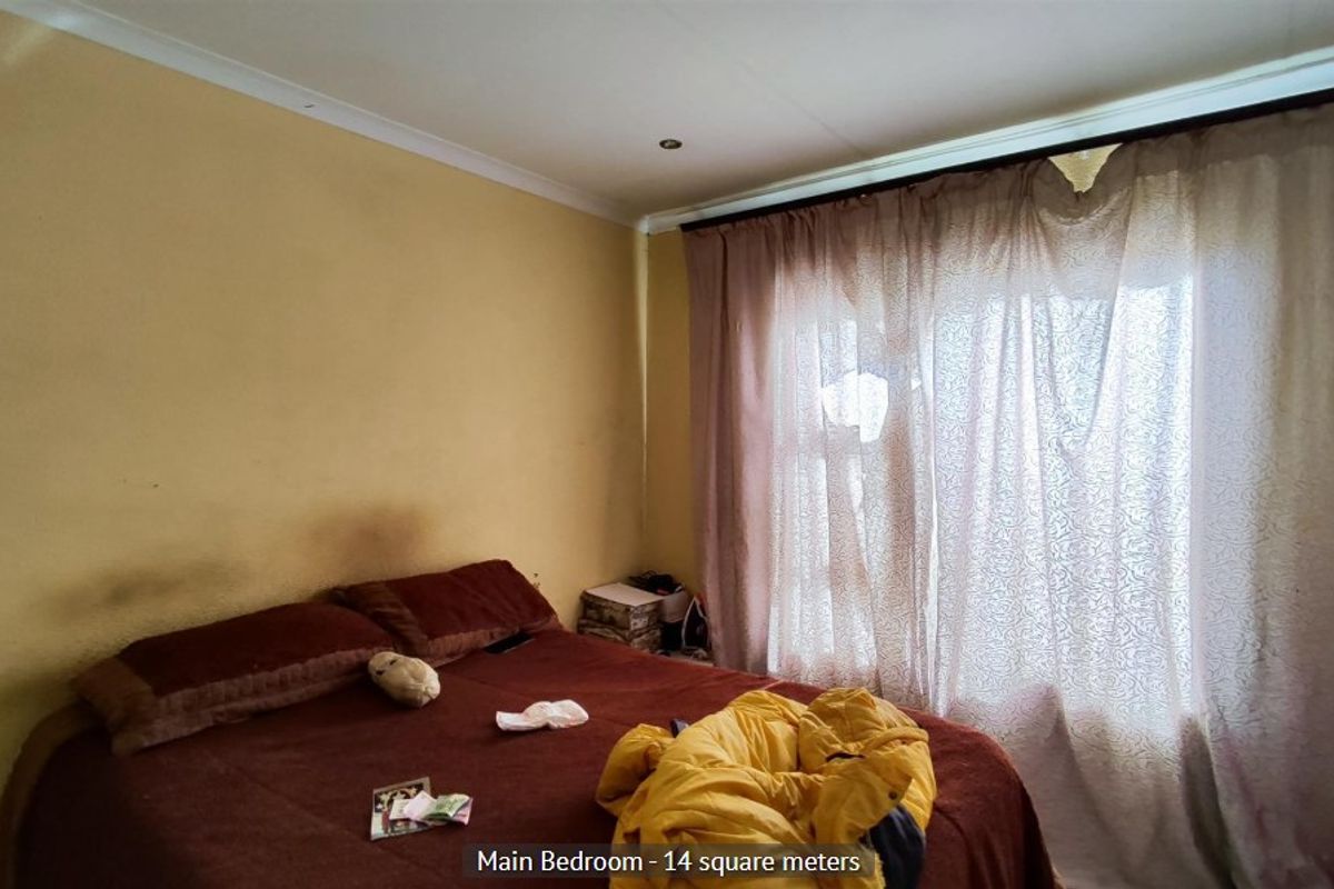 A bedroom featuring recessed downlights and coved ceilings, currently requiring cosmetic updates to the wall finishes.