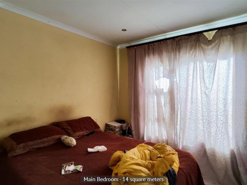 A bedroom featuring recessed downlights and coved ceilings, currently requiring cosmetic updates to the wall finishes.