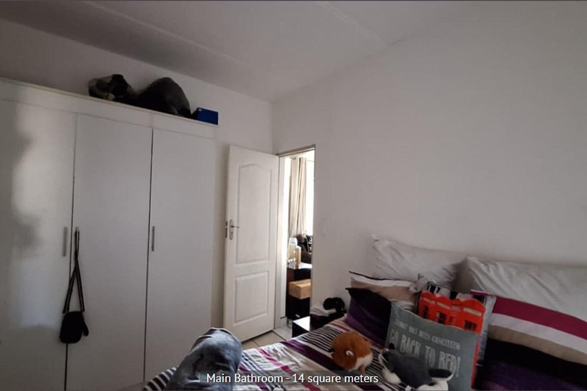 A bedroom featuring a built-in wardrobe and access to an adjoining room.