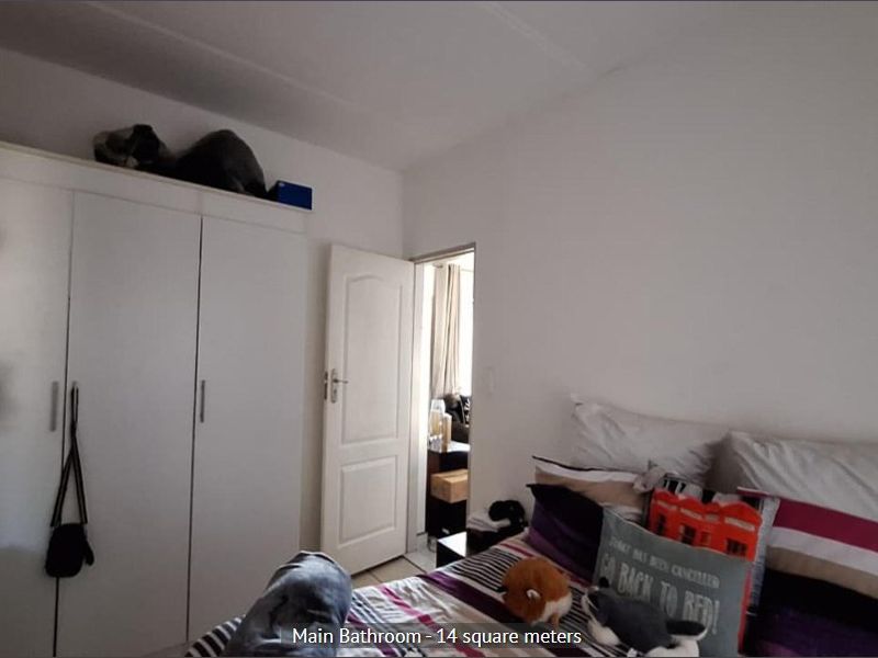 A bedroom featuring a built-in wardrobe and access to an adjoining room.