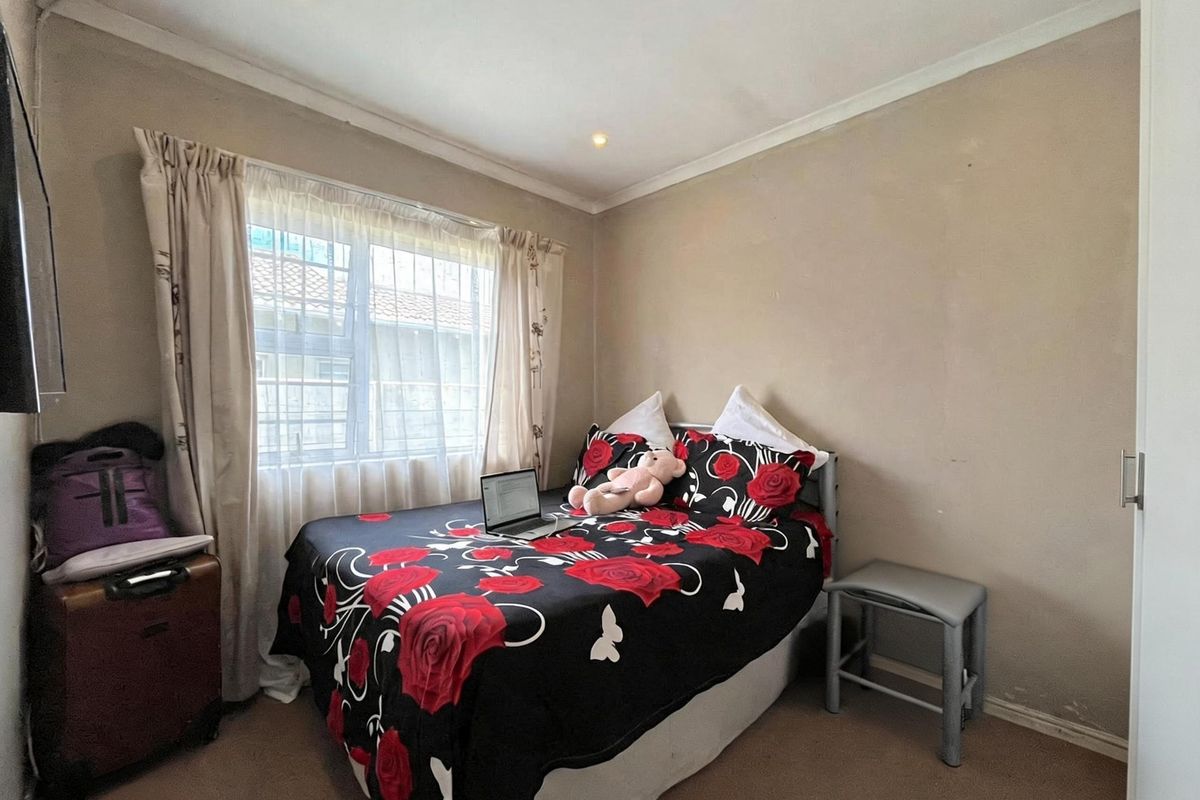A standard bedroom featuring recessed downlights, coving, and carpeted flooring, offering a functional space ready for cosmetic updates.