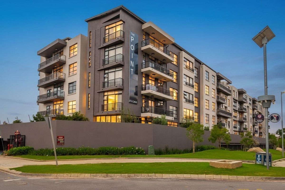 Modern multi-story apartment complex featuring contemporary architectural design, private balconies, and well-maintained surrounding landscaping.