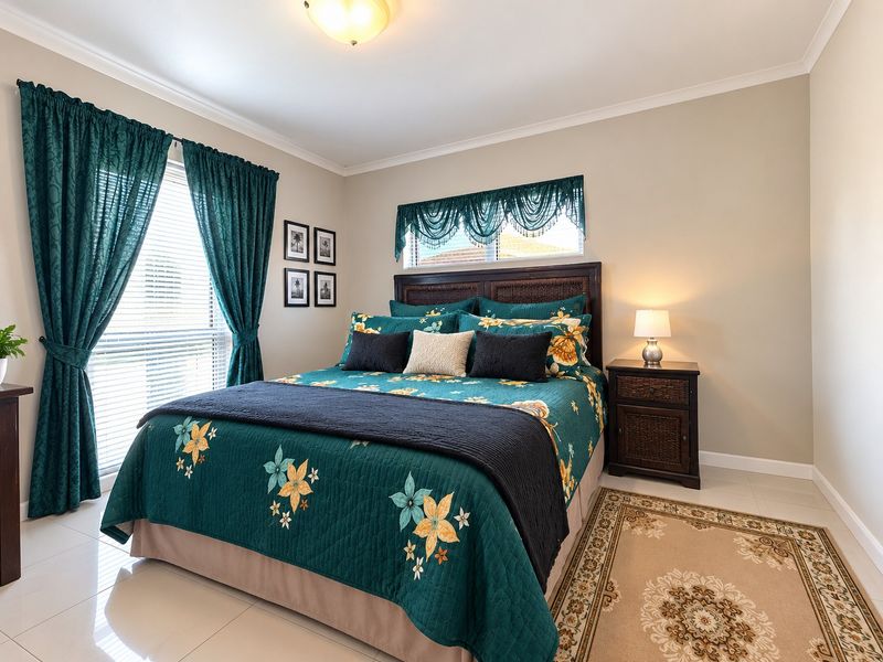 A well-maintained bedroom featuring neutral wall tones, tiled flooring, and natural light through window blinds.