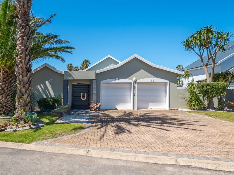 A well-maintained single-story residential property featuring a double garage, paved driveway, and a modern front entrance.