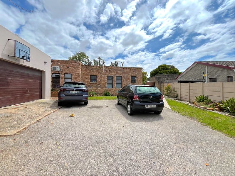 Front exterior view of the property featuring a brick facade, a single garage, and an asphalt driveway providing off-street parking.