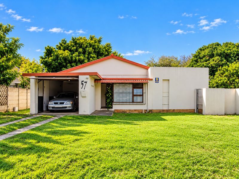 Front elevation of a single-story house featuring a single garage, tiled roof, and a well-maintained front lawn.