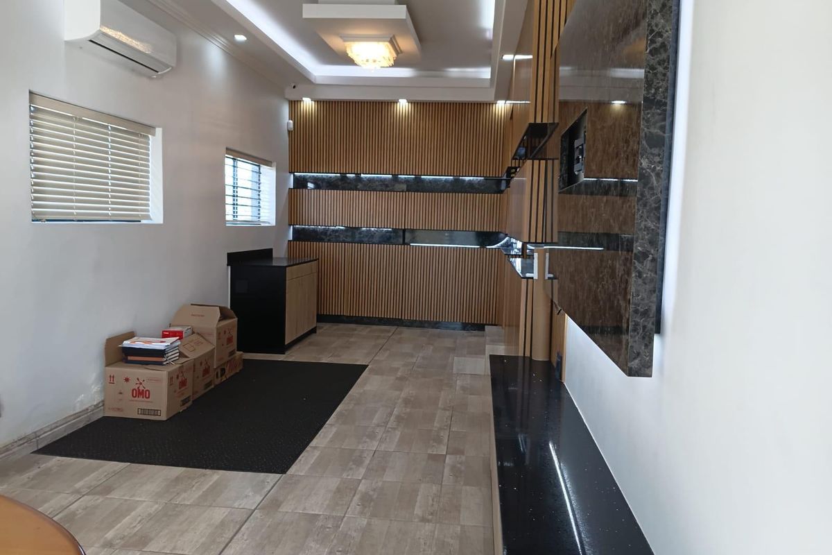 Modern living area featuring contemporary timber slat wall paneling, marble-look accents, recessed ceiling lighting, and split-system air conditioning.