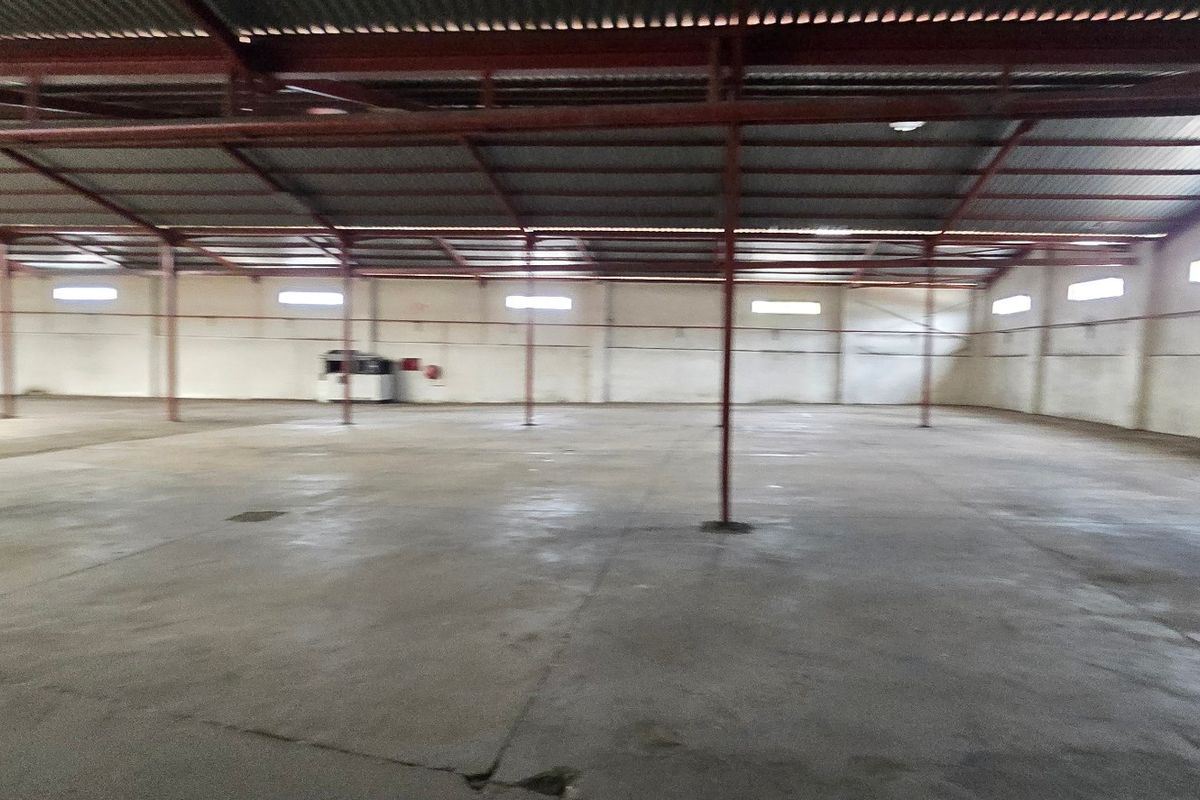 Spacious industrial warehouse featuring a high-clearance steel portal frame, concrete flooring, and natural light provided by high-level clerestory windows.