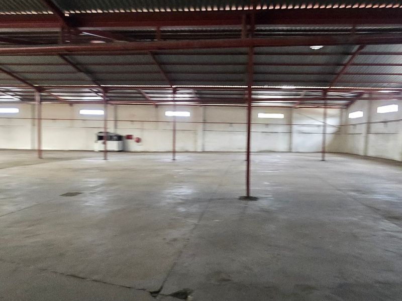 Spacious industrial warehouse featuring a high-clearance steel portal frame, concrete flooring, and natural light provided by high-level clerestory windows.