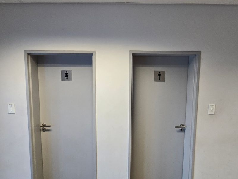A hallway featuring two separate doors for male and female restroom facilities.