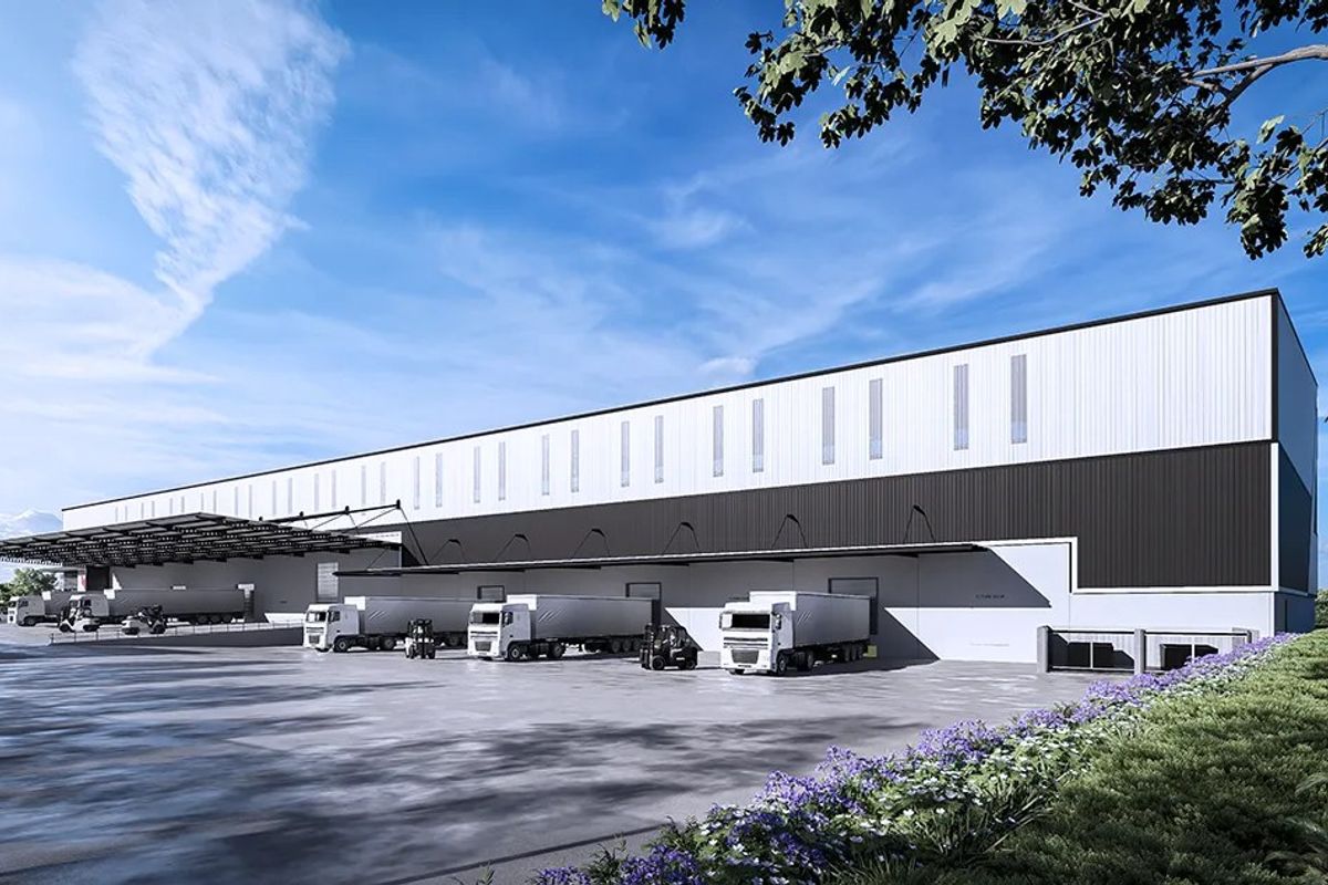 Modern industrial warehouse facility featuring extensive loading docks, a large concrete hardstand area, and high-clearance cladding with integrated clerestory windows.