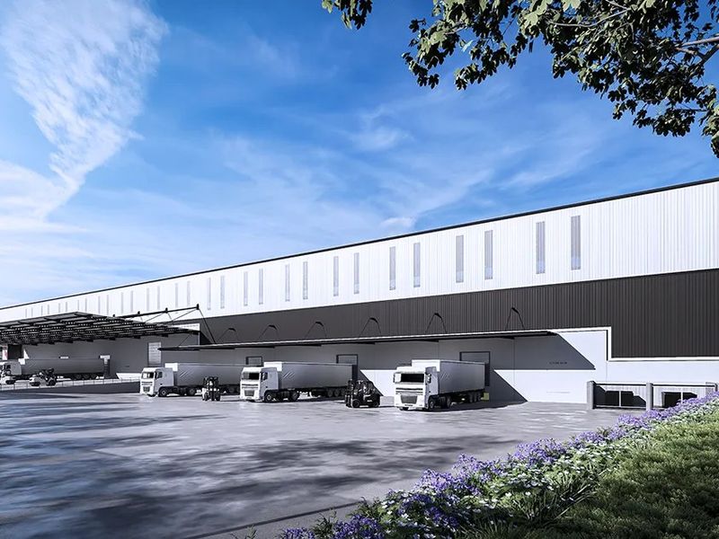 Modern industrial warehouse facility featuring extensive loading docks, a large concrete hardstand area, and high-clearance cladding with integrated clerestory windows.