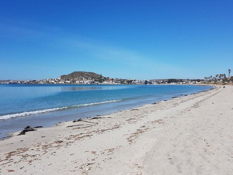 A scenic view of the sandy coastline and ocean, showcasing the natural beauty and proximity to the water.