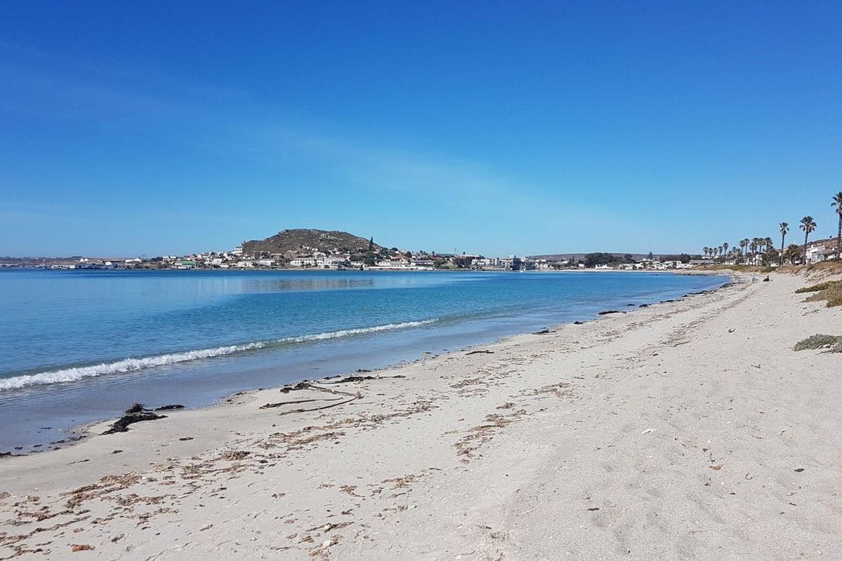 A scenic view of the sandy coastline and ocean, showcasing the natural beauty and proximity to the water.