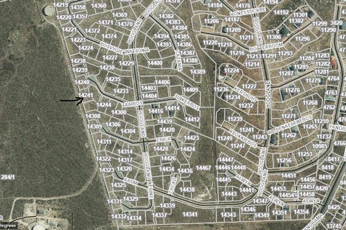 An aerial view of a residential estate showing the layout of vacant land plots and street infrastructure.