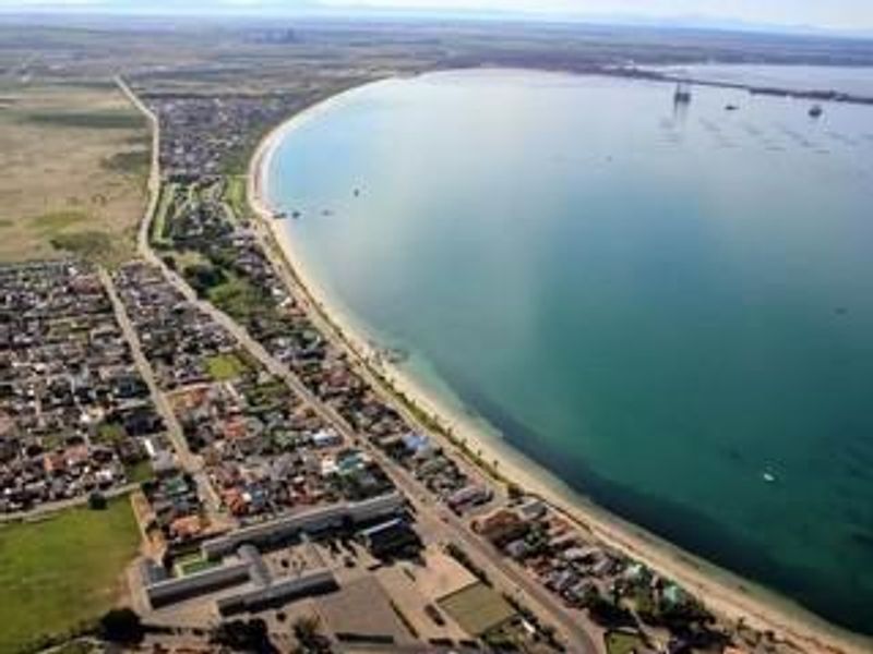 An aerial view of the coastal residential area, showcasing the proximity to the beach and the surrounding urban layout.