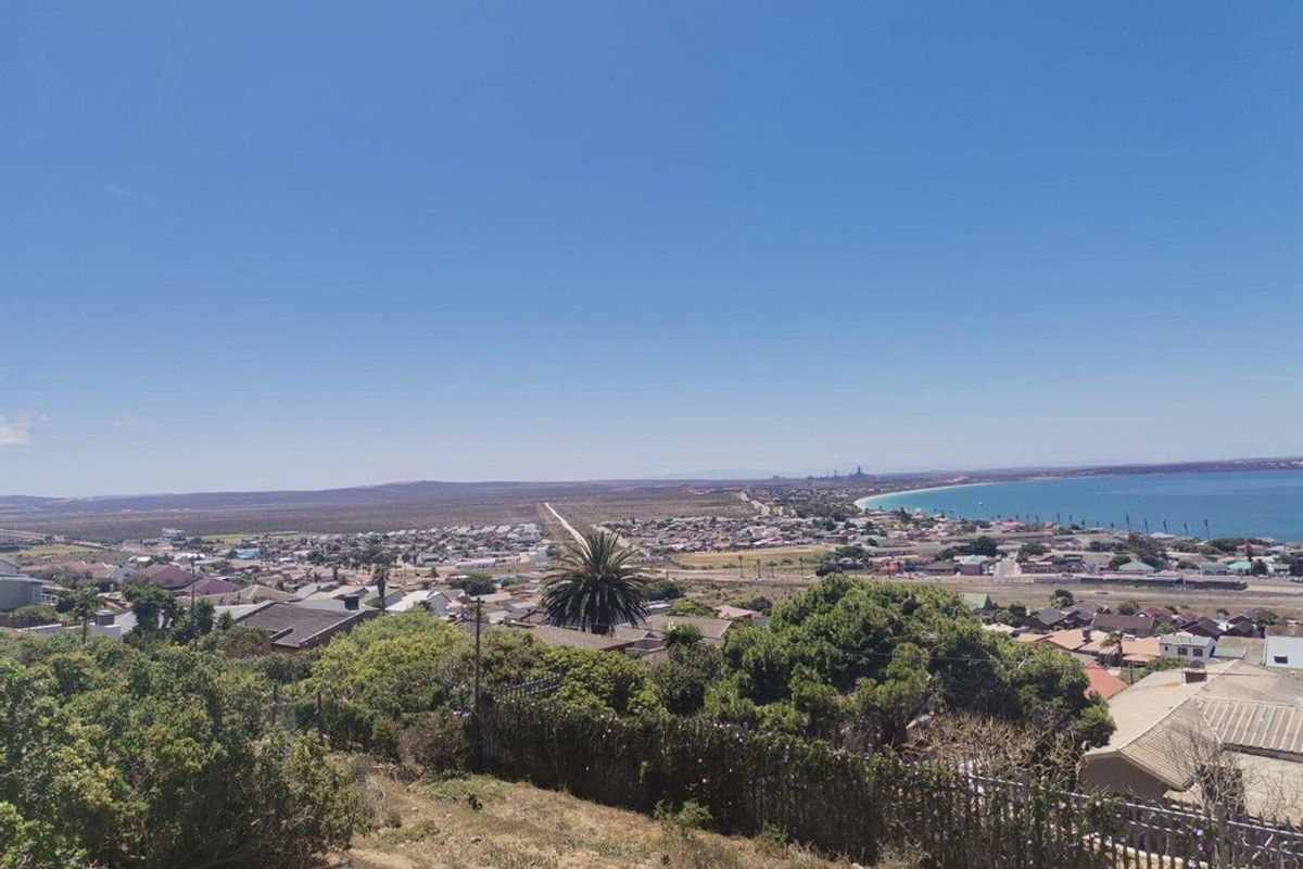 Elevated panoramic view overlooking the coastal town, surrounding landscape, and ocean horizon.
